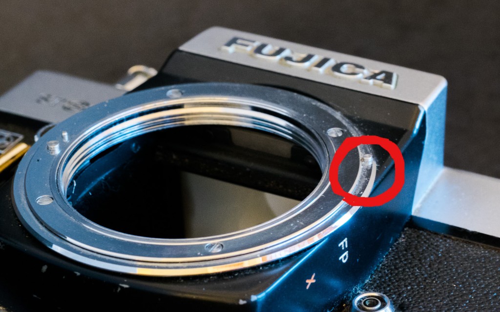 Fujica ST 801: Fuji's version of the m42 lens mount has a ring at the periphery - the little pin in the red circle is pushed by the tab protruding from the aperture ring of the lens. That's how the preselected aperture is transmitted.