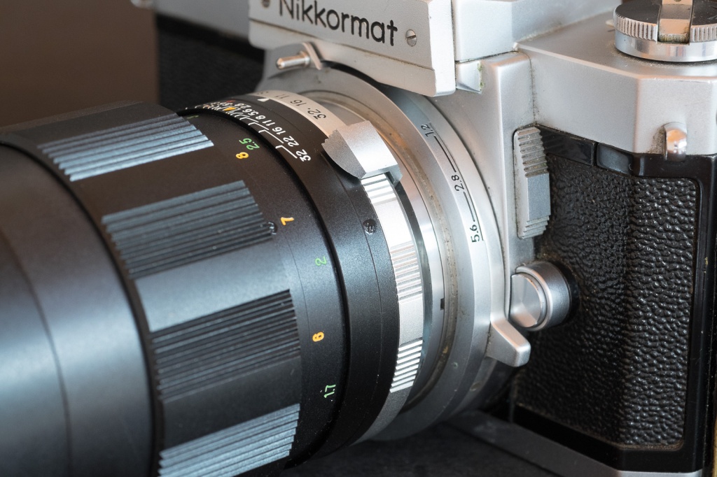 This big lever on this Nikkorex lens has to be pushed down to re-arm the pre-selection system after each shot 